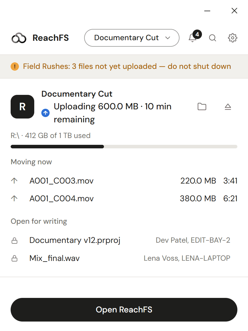 The tray popover: 600 MB uploading with ten minutes left, a warning that another drive has files not yet uploaded, and two files open on other computers.